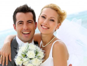 Cheerful married couple standing on the beach